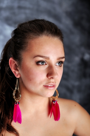 Young woman portrait with long red earringsの写真素材