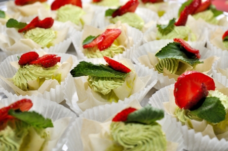 Tartlets with cream, strawberry and mint leafの写真素材