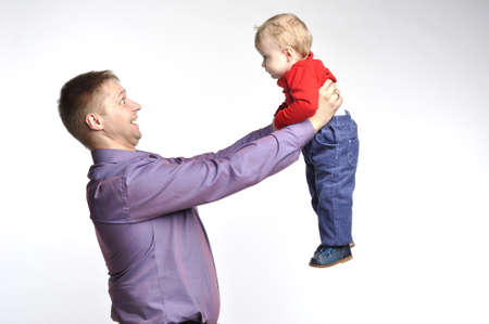 Father in violet shirt holds little boyの写真素材