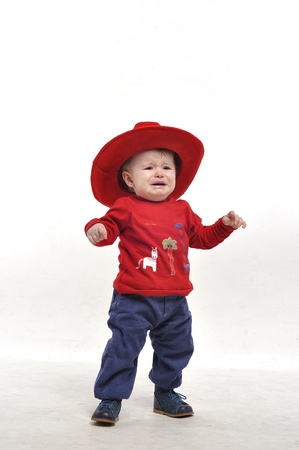 Little boy in red hat cryingの写真素材