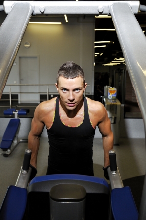 Young athlete pulls body in sportclubの写真素材