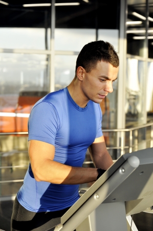 Young man includes treadmillの写真素材