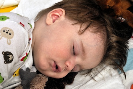 Very closeup portrait of the hairy sleeping babyの写真素材