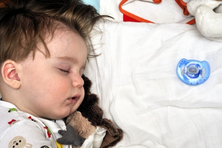 Very closeup portrait of the sleeping baby with dummies nearblyの写真素材