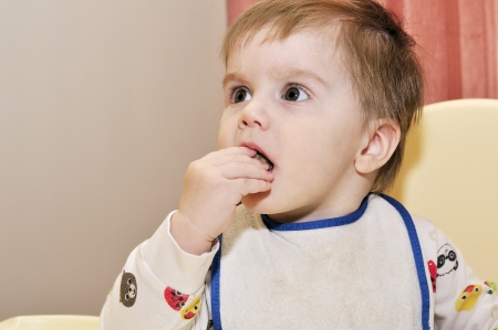 Cute baby eat with hands helpの写真素材
