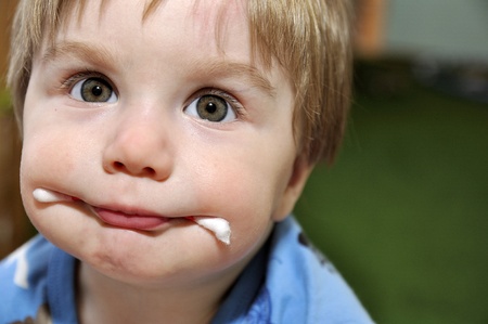Baby with wadded stick in mouthの写真素材