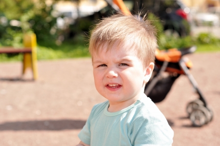 Little boy outdoor portrait in sunlightの写真素材