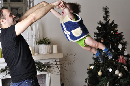 Little boy with young father play the fool in studioの写真素材