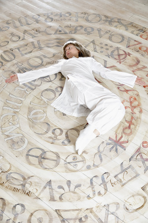Young woman in white dress relaxing with yoga styleの写真素材