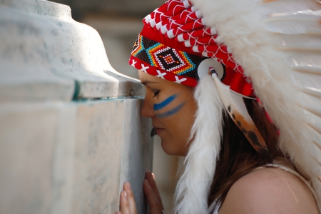 Young woman in war bonnet headdress of American Indian