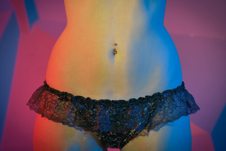 Young woman with a sexy body in underwear with backlight shining