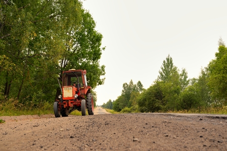Old Russian tractor on gravel roadの写真素材
