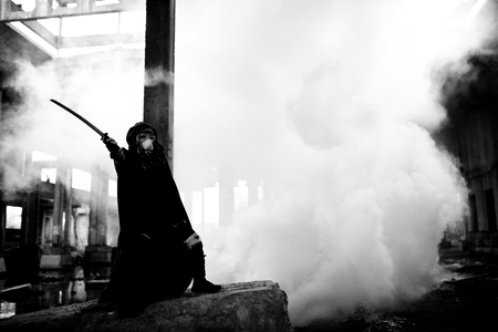 Woman killer holding Japanese sword on a post-apocalyptical landscape