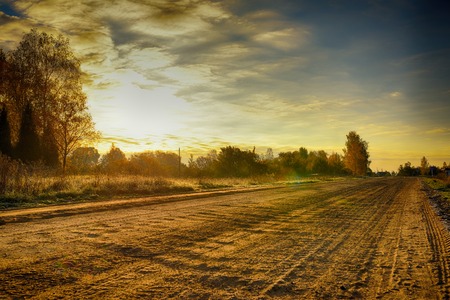 Road in rural district in autumn timeの写真素材