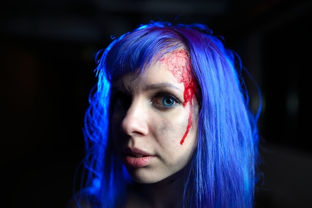 Portrait of sexy woman with blue hair looking as killer victimの写真素材