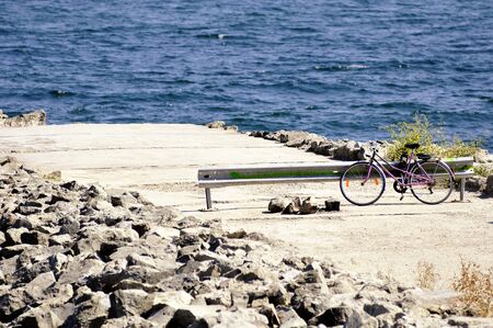 Old style bicycle on the embankmentの写真素材
