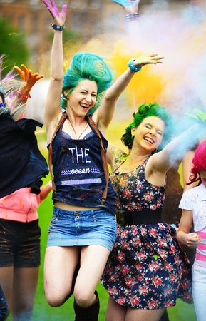 Two girl during Holi festival throw color paintsの写真素材