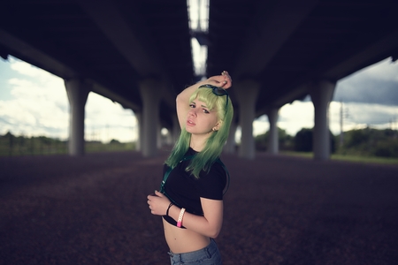 Young fashion swag girl under highway road intersectionの写真素材