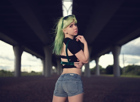 Young fashion swag girl under highway road intersectionの写真素材