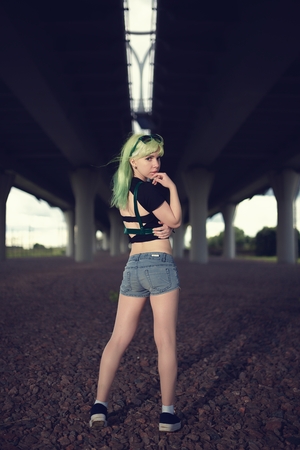 Young fashion swag girl under highway road intersectionの写真素材