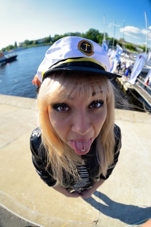 Fun fisheye view on girl looking as seamenの写真素材