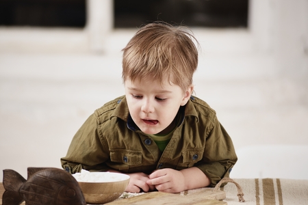 Little boy plays at a table