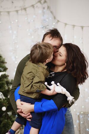 Happy family with against decorating Christmas treeの写真素材