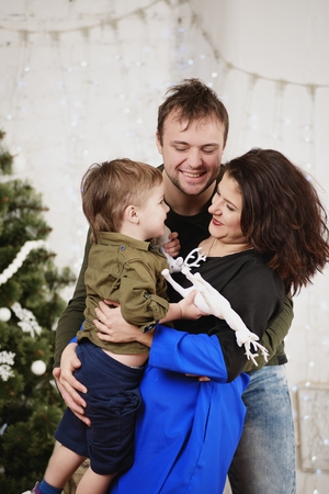 Happy family with against decorating Christmas treeの写真素材