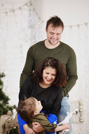 Happy family with against decorating Christmas treeの写真素材