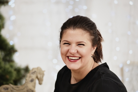 Portrait young laughing woman. Daisy background.の写真素材
