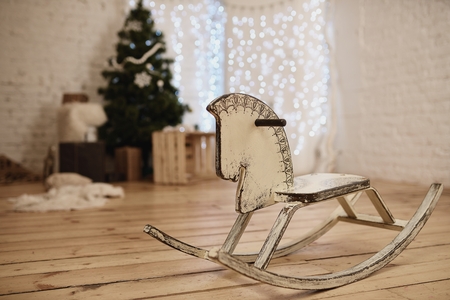 Wooden rocking horse in decorated by Christmas to roomの写真素材