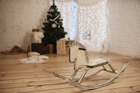 Wooden rocking horse in decorated by Christmas to roomの写真素材