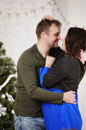 Young husband and wife laugh in Christmas decorate roomの写真素材