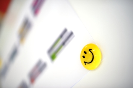 Yellow magnet with smiley face on flipchartの写真素材
