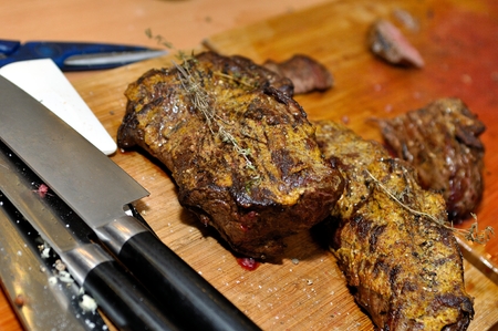 Made meat on chopping board with knivesの写真素材