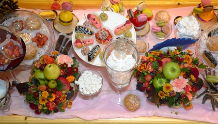 Table served sweet dessert and fruitsの写真素材