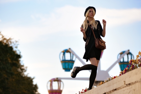 Young pretty hipster girl outdoor in sunny day, wearing casual clothiers hatの写真素材