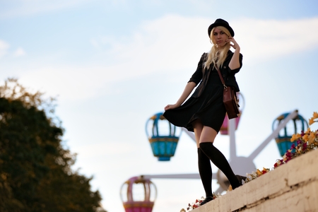 Young pretty hipster girl outdoor in sunny day, wearing casual clothiers hatの写真素材