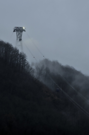 Cable car in foggy wood on mystical mountainの写真素材
