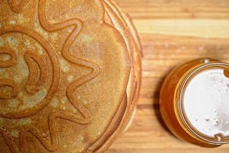 Pancakes and jar of honey on wooden boardの写真素材