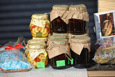 Homemade honey and jam in jar on fair marketの写真素材