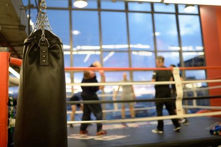 Black leather boxing bag in gymの写真素材