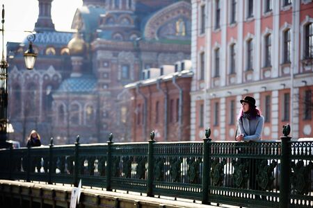 Stylish, young and beautiful girl with color hair poses on streets of St. Petersburgの写真素材