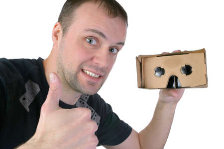 Young man uses virtual reality (VR cardboard) isolated on white backgroundの写真素材