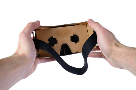 Male hands hold VR glasses isolated on white backgroundの写真素材