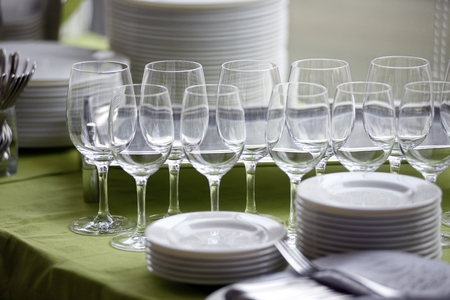 Served table with empty glasses and platesの写真素材
