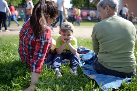 Dissatisfied little boy listens to manual of adultsの写真素材