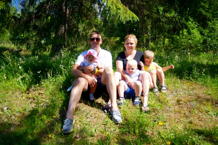 Happy family with three children outdoorsの写真素材