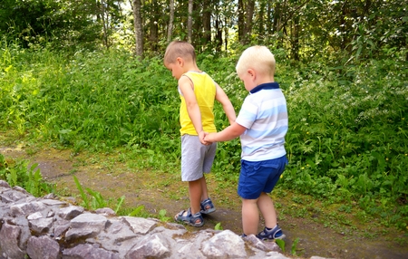 Two little brothers play outdoorsの写真素材