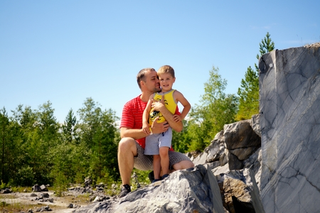 Father and son on big stoneの写真素材